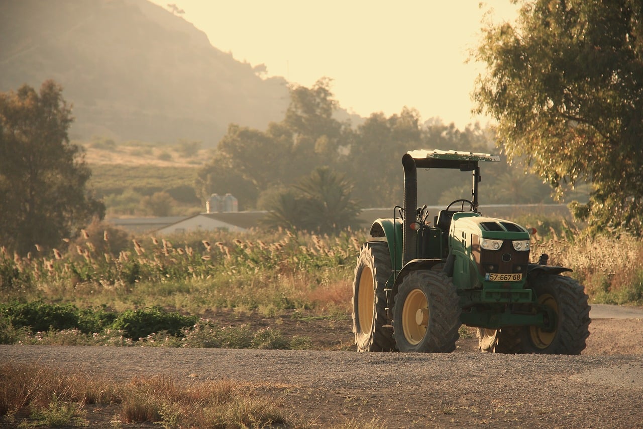 tractor and farmer working in field agriculture USA